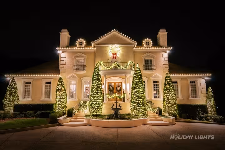Elegant roofline Christmas lights with decorated evergreen trees for New England homes