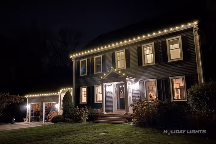Cohasset MA home professionally decorated with Christmas lights and holiday displays