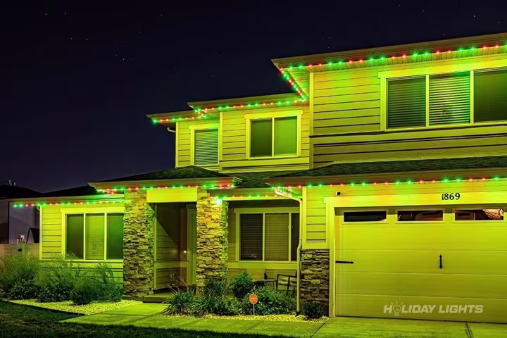 Permanent roofline lights installed along the full eaves of a New Hampshire home